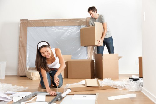 Professional piano movers handling an upright piano in Croydon