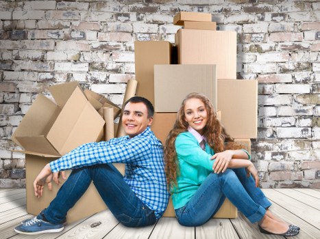Professional removalists loading household boxes safely
