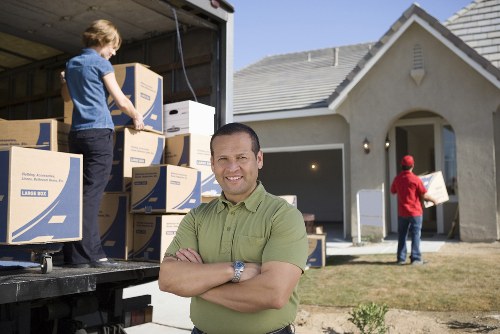 Boxes and furniture being loaded into a removals van